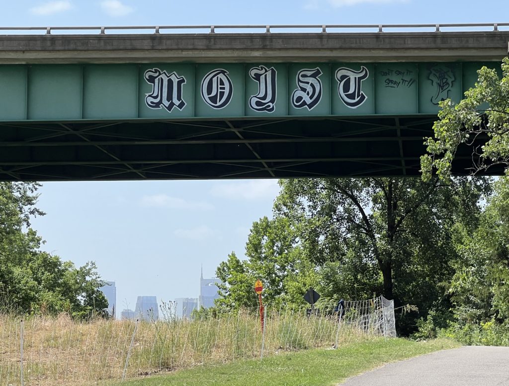 Bridge with the word "Moist" in large ornate letters Graffitied on the side