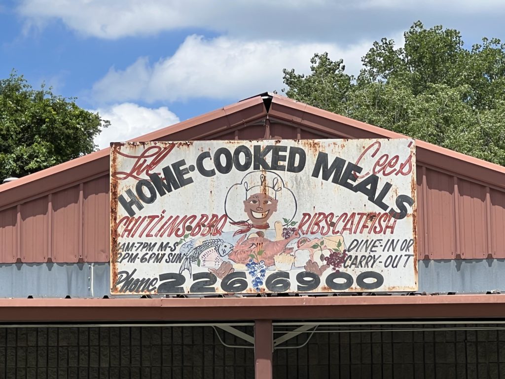 Weathered sign advertising "home cooked meals"